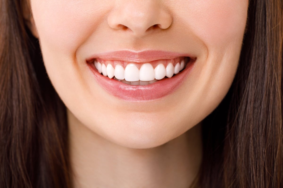 A beautiful woman is smiling. a smile with white teeth. Close up image