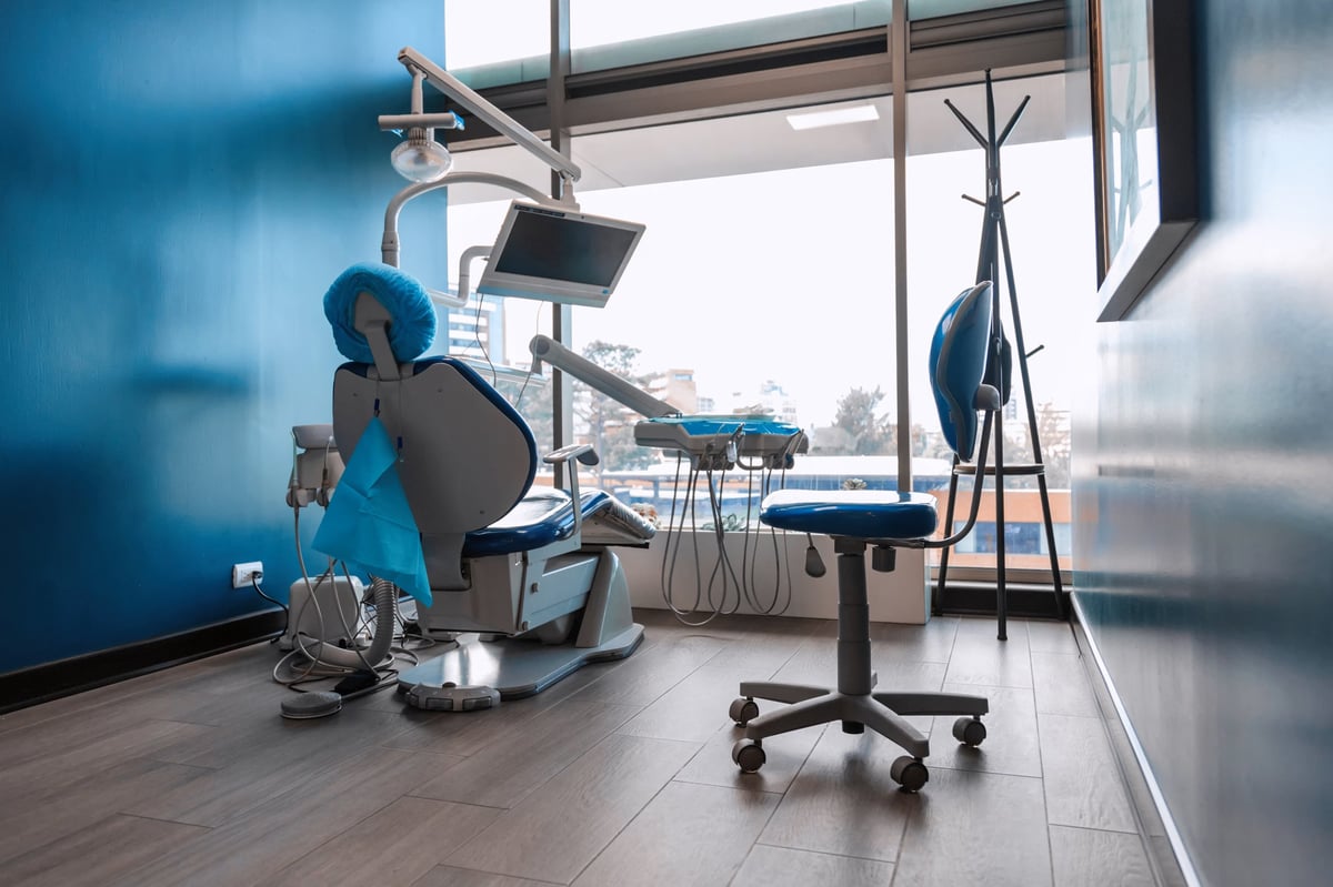 Contemporary dental chair setup in a clinic with tools and monitor